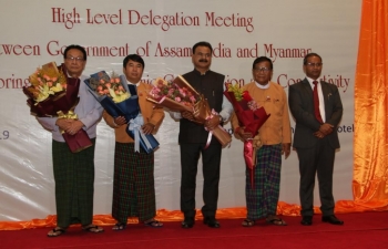 Consul General presenting flower bouquet to H.E. Dr. Zaw Myint Maung, Hon. Chief Minister, Mandalay Region, during  High Level Meeting between Govt of Assam and Myanmar for exploring greater Economic Cooperation and Connectivity.